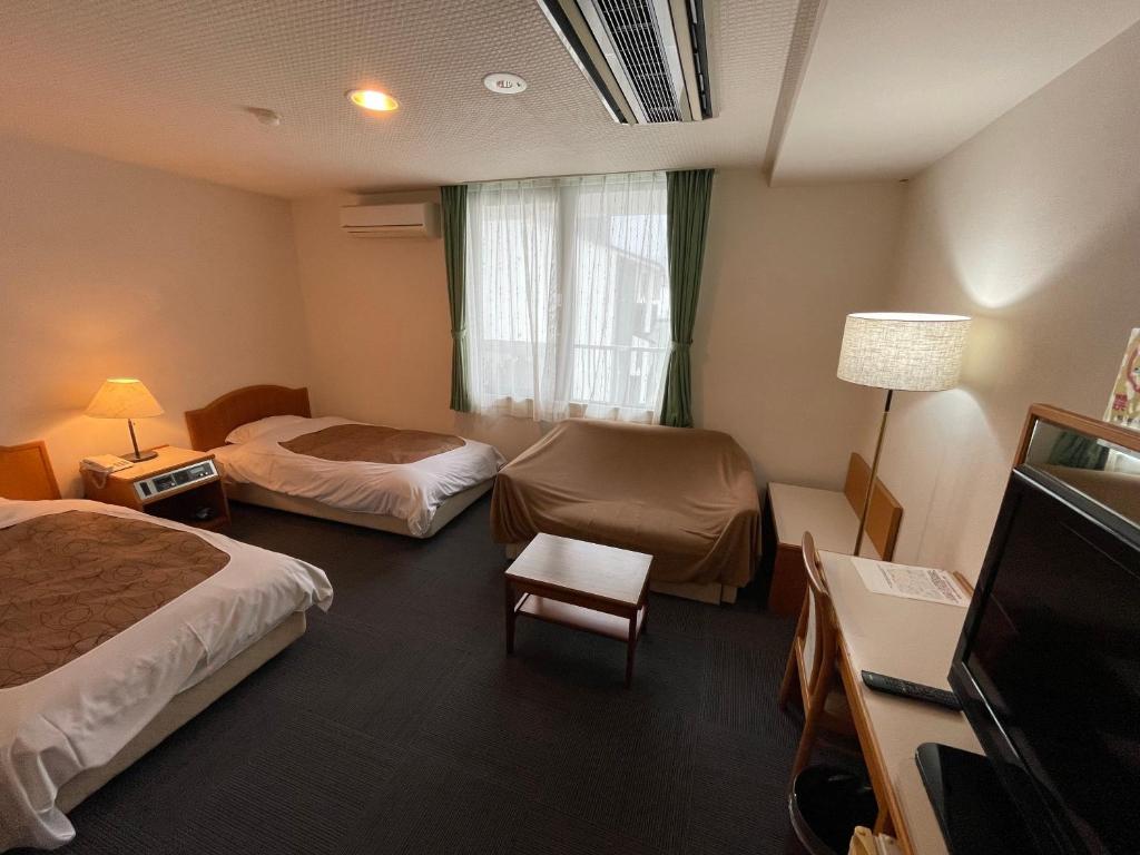 Postel nebo postele na pokoji v ubytování Hotel Ginsui