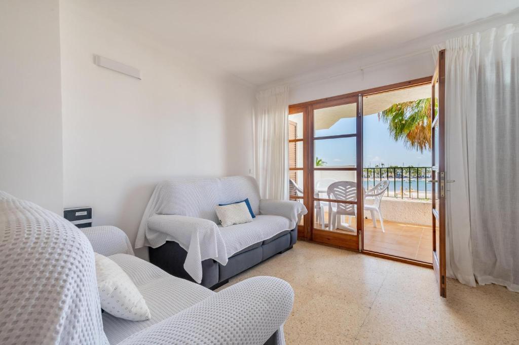 a living room with a couch and a balcony at Apartamento Carabela Greco 139 in Alcudia
