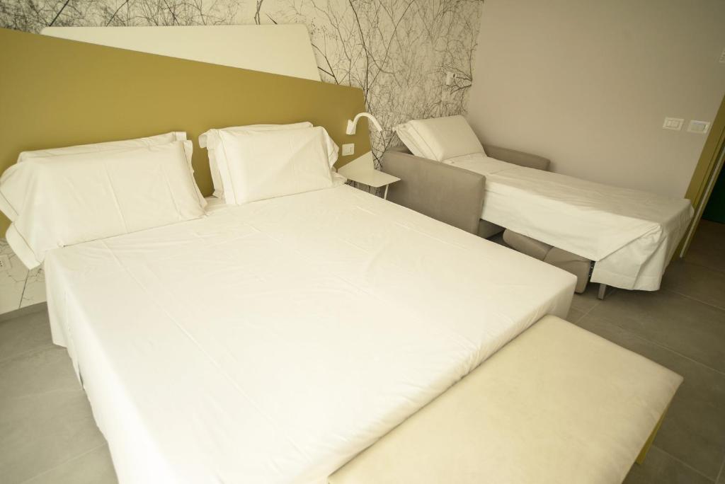Posteľ alebo postele v izbe v ubytovaní Hotel Malavoglia