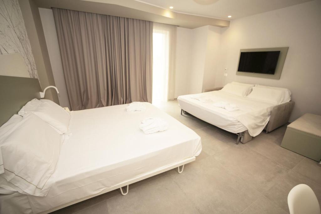 Posteľ alebo postele v izbe v ubytovaní Hotel Malavoglia