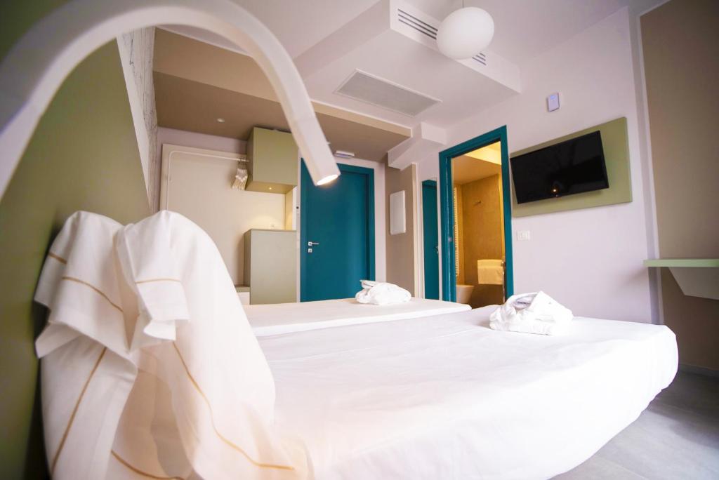 Posteľ alebo postele v izbe v ubytovaní Hotel Malavoglia