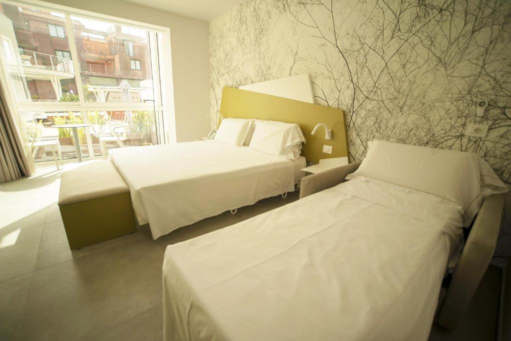 Posteľ alebo postele v izbe v ubytovaní Hotel Malavoglia