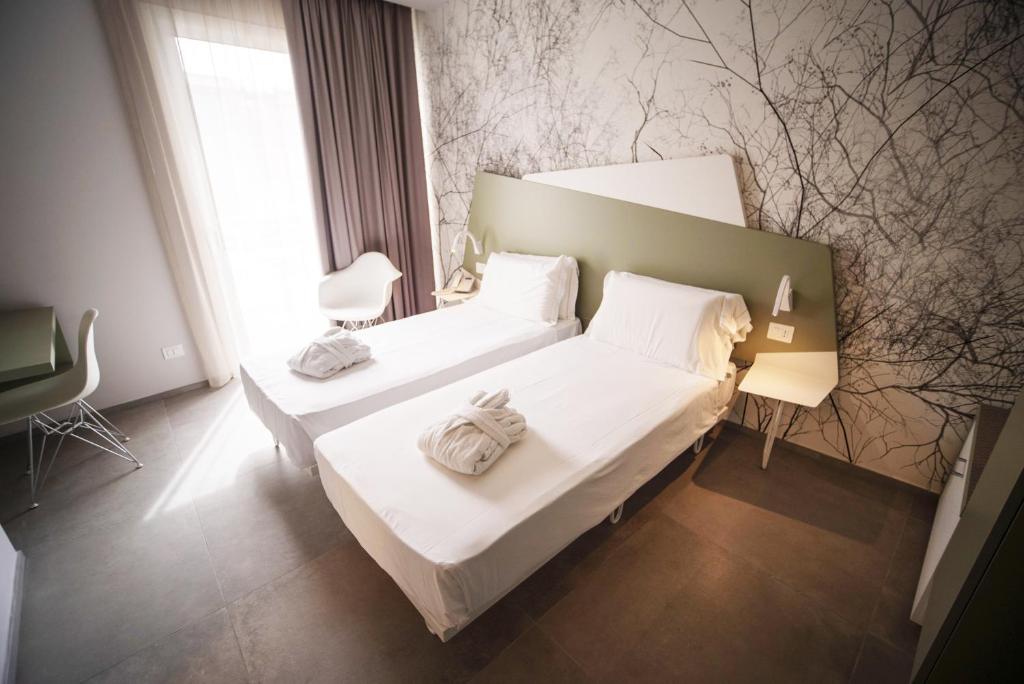 Posteľ alebo postele v izbe v ubytovaní Hotel Malavoglia