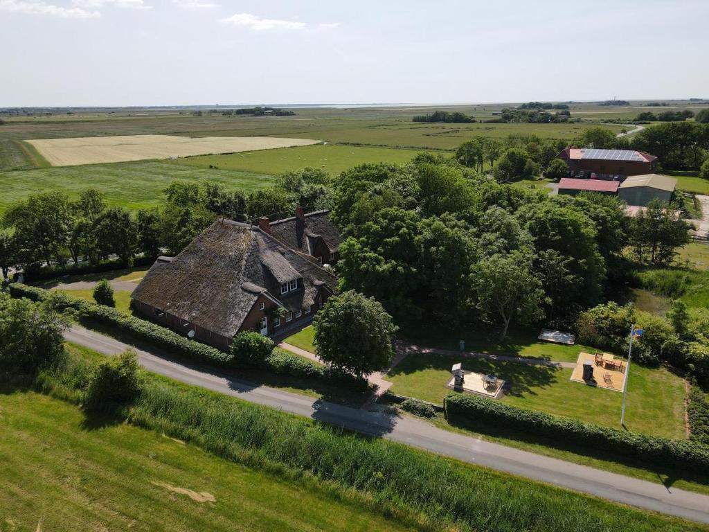 an aerial view of an old house on a road at Haubarg alte Strandvogtei in Westerhever