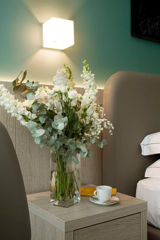 Uma cama ou camas num quarto em Hotel Raffaello