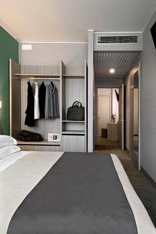 Uma cama ou camas num quarto em Hotel Raffaello