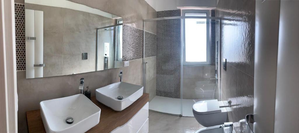 a bathroom with a sink and a toilet and a mirror at MERAVIGLIOSO in Polignano a Mare