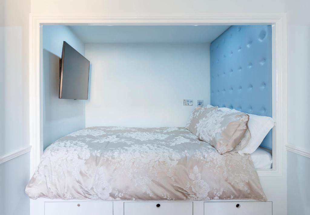 a bedroom with a bed with a mirror at The Beetroot in Margate