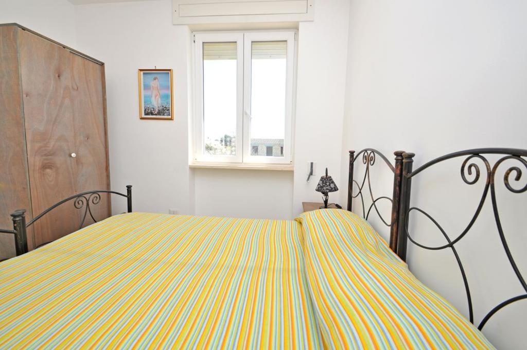 Postel nebo postele na pokoji v ubytování Residence Punta Pizzo