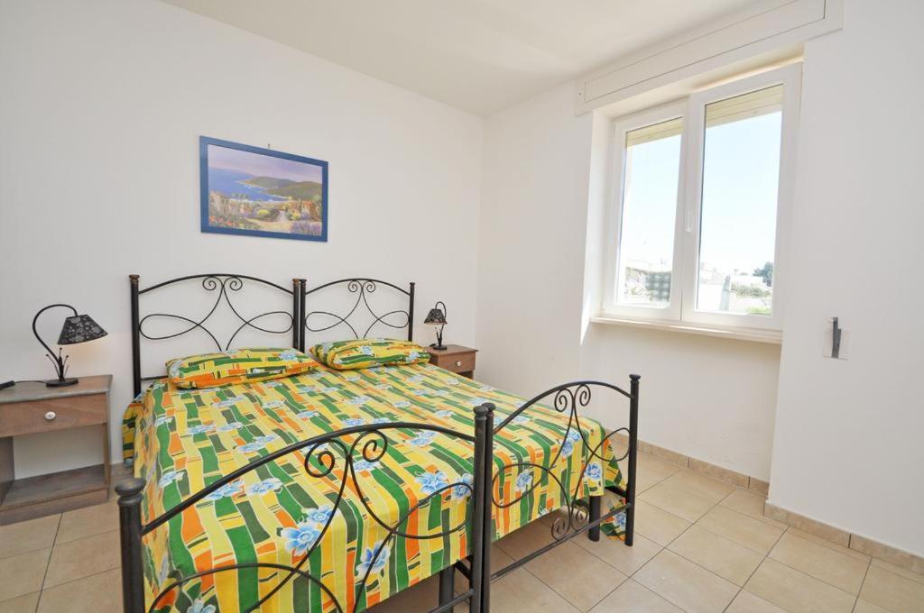Postel nebo postele na pokoji v ubytování Residence Punta Pizzo