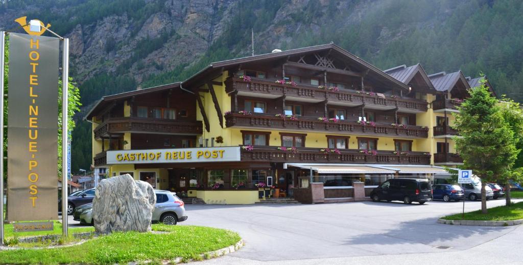 a large hotel with cars parked in front of it at Hotel Neue Post in Sölden