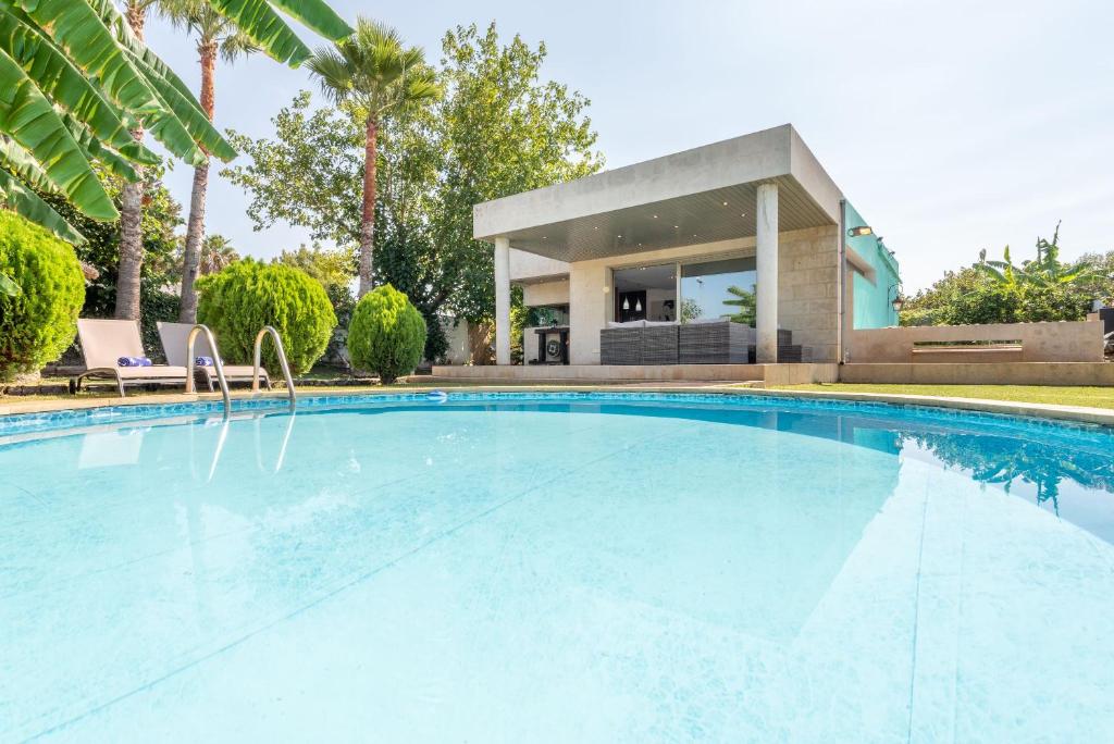 a swimming pool in front of a house at Villa Zoe in Palma de Mallorca