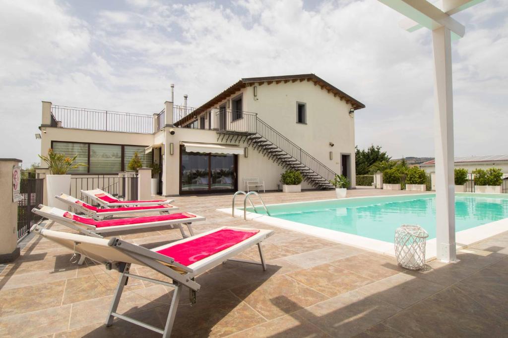 a villa with a swimming pool and a house at Agriturismo Alpa in Mazzarino