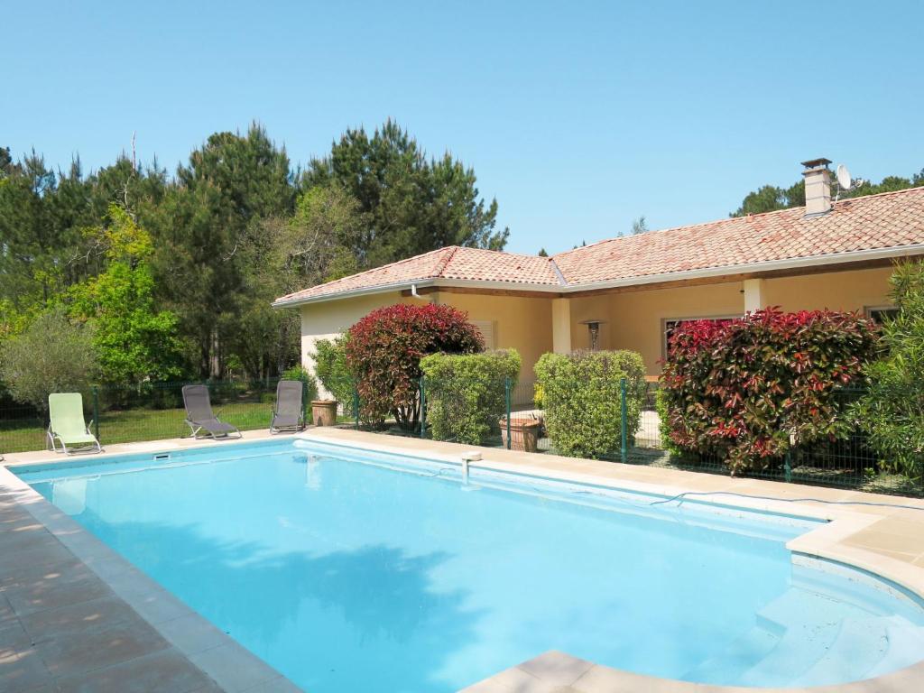 a swimming pool in front of a house at Holiday Home Eugénie - GHP190 by Interhome in Grayan-et-lʼHôpital