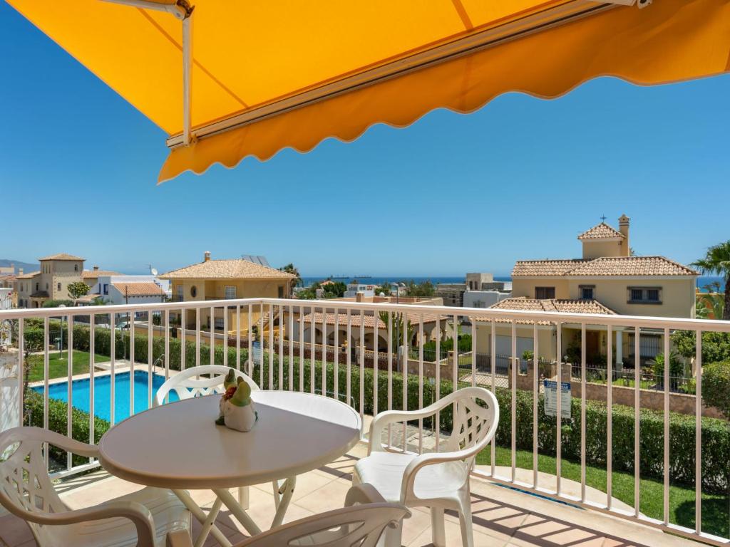 a balcony with a table and chairs and a pool at Apartment Sierra Mar by Interhome in Los Amarguillos