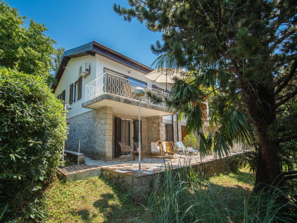 an exterior view of a house with a tree at Holiday Home Vesna by Interhome in Njivice