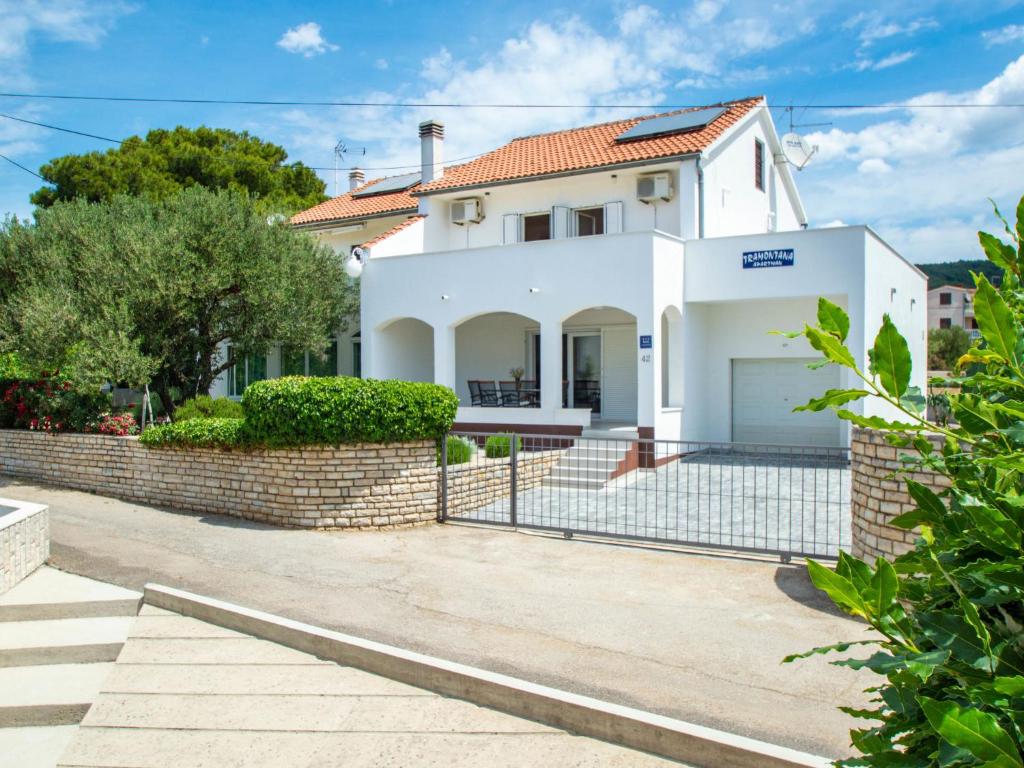 a white house with a brick fence at Holiday Home Tramontana by Interhome in Sovlje
