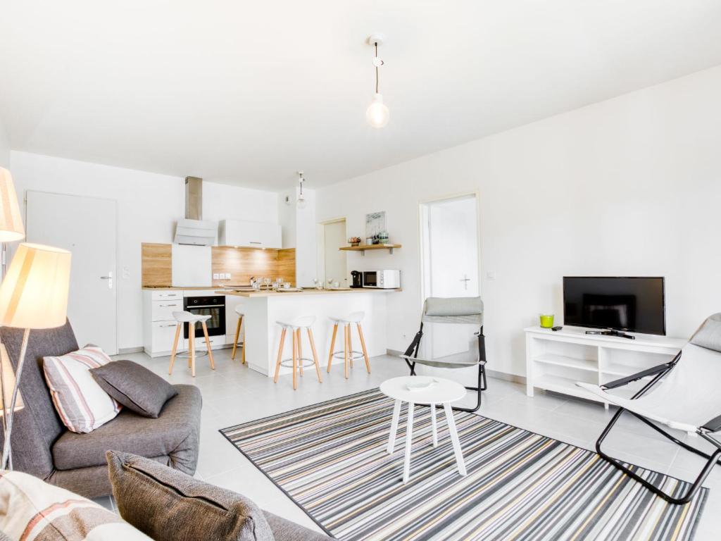 a living room with a couch and a table at Apartment les Terrasses de Capbreton-2 by Interhome in Capbreton