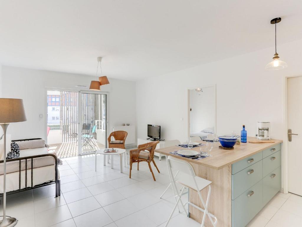 a kitchen and dining room with a table and chairs at Apartment les Terrasses de Capbreton-1 by Interhome in Capbreton