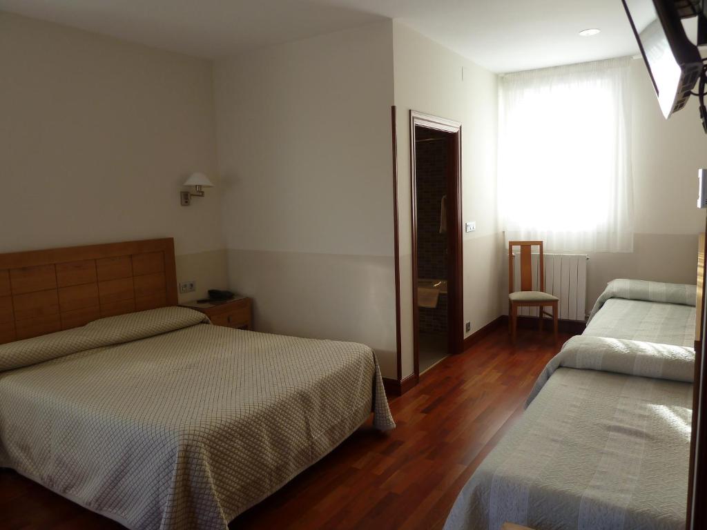 A bed or beds in a room at Hotel Leku Eder