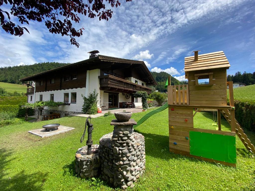 a house with a playground and a building at Glückchalet in Rettenschöss