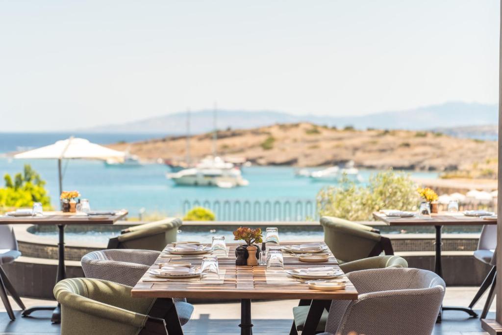 a restaurant with tables and chairs and a view of a harbor at METT Hotel & Beach Resort Bodrum in Bodrum City