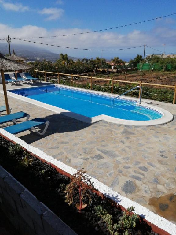 a large swimming pool with a fence around it at Finca Pozo Taburiente in El Paso