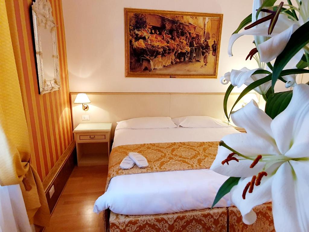 Postel nebo postele na pokoji v ubytování Hotel Corte dei Greci