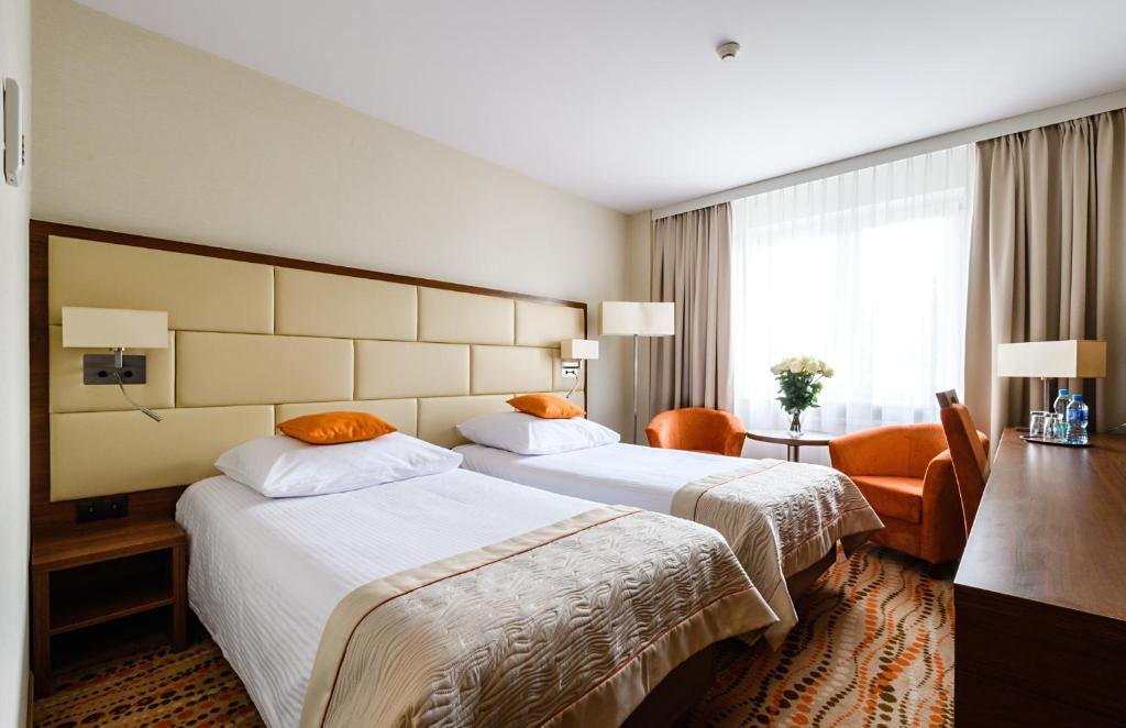 
a hotel room with two beds and two lamps at Hotel Boss in Warsaw
