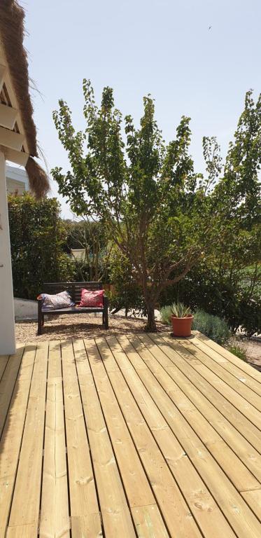 a bench sitting on top of a wooden deck at Comporta House in Comporta