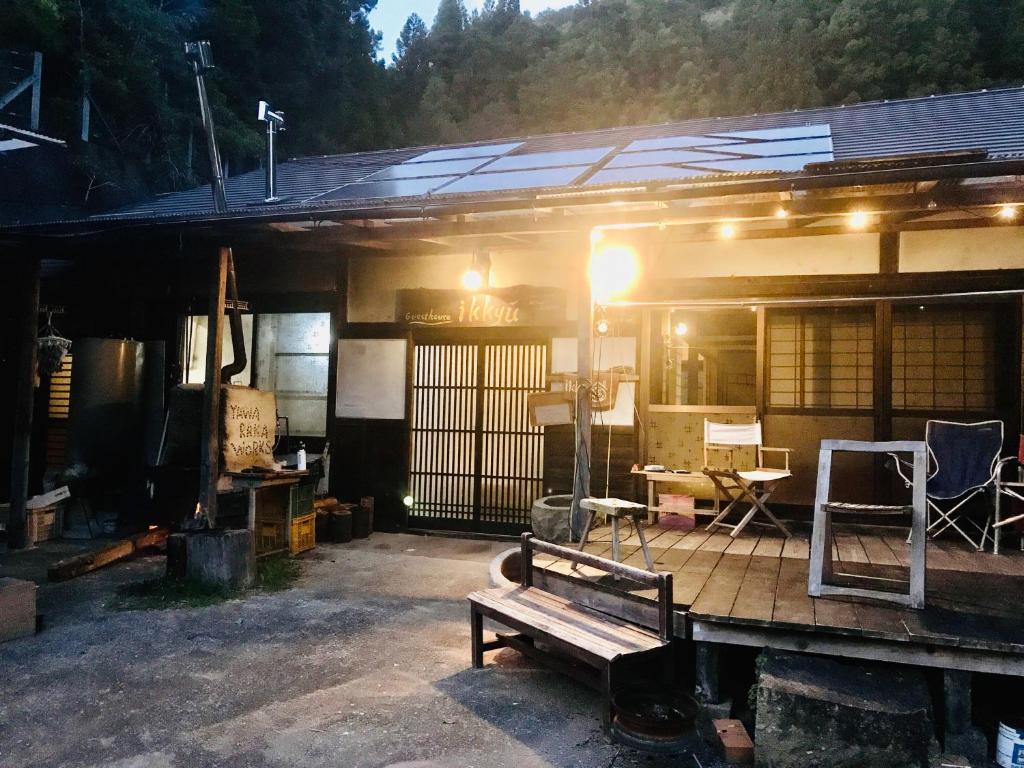a house with a bench in front of it at ikkyu rental vacation house in Kobune
