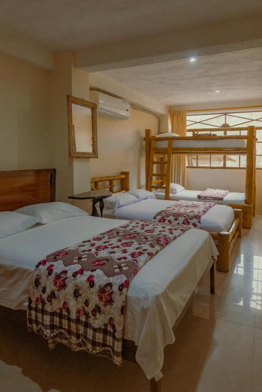 Postel nebo postele na pokoji v ubytování Hostal Poseidon
