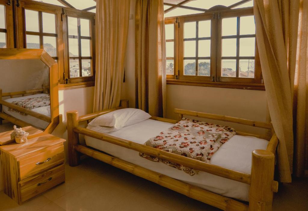 Postel nebo postele na pokoji v ubytování Hostal Poseidon