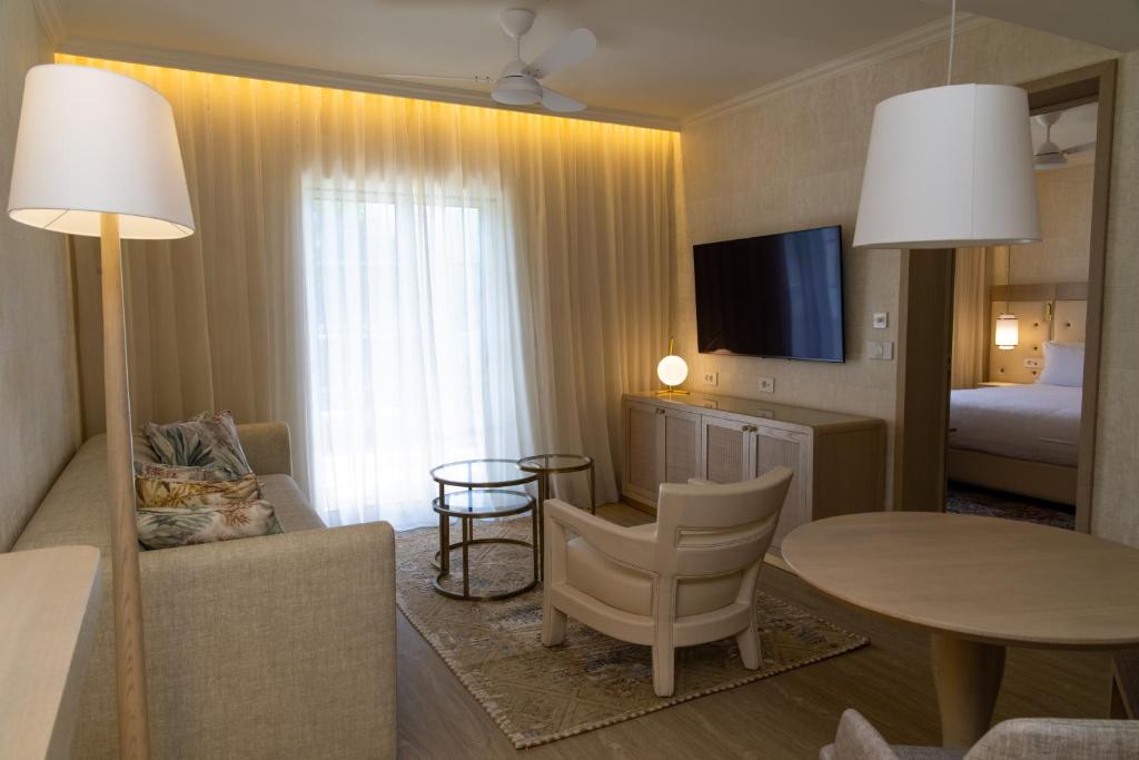 a living room with a couch and a table in a room at Vila Alba Resort in Carvoeiro