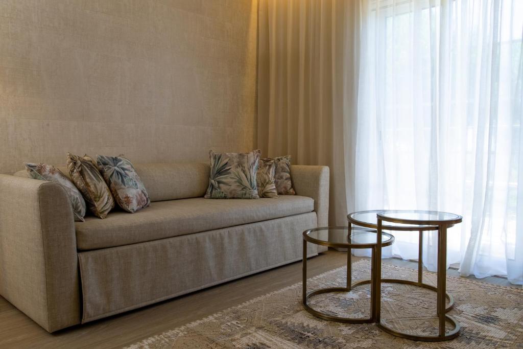 a living room with a couch and two tables at Vila Alba Resort in Carvoeiro