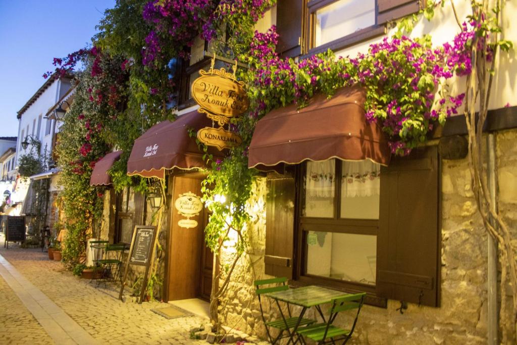 a street with flowers on the side of a building at Villa Teos Otel in Izmir