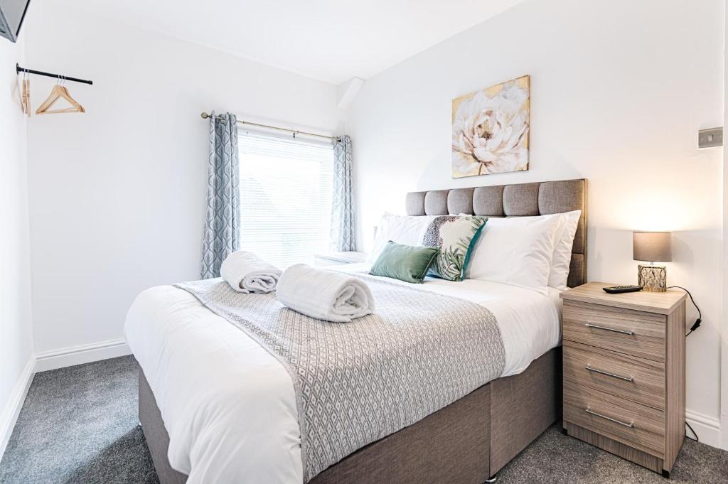 a bedroom with a large bed and a window at The Valley Home - TV in every room! in Brynamman