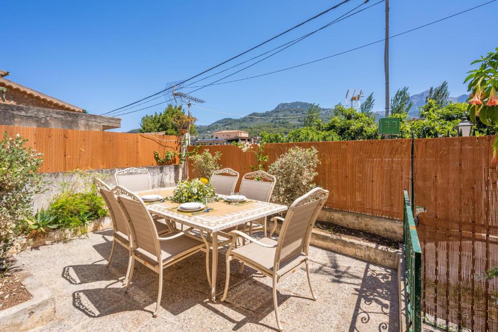 a patio with a table and chairs and a fence at Casa Tramuntana in Sóller