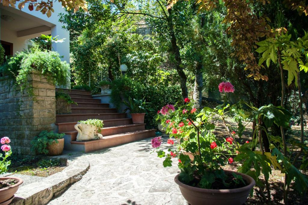 a garden with a bunch of flowers and stairs at 4 bedrooms house with lake view enclosed garden and wifi at Amelia in Amelia