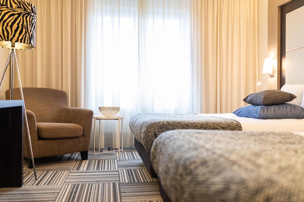 Postel nebo postele na pokoji v ubytování Hotel Malpertuus