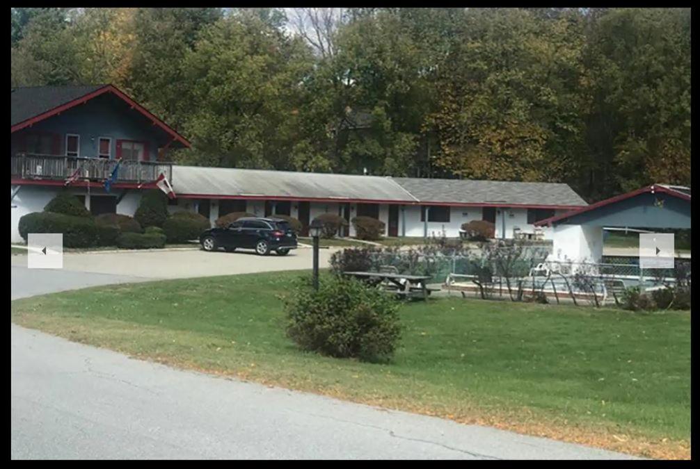 a building with a car parked in front of it at The Chalet Motel by Wyndham in Manchester