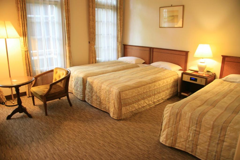 Postel nebo postele na pokoji v ubytování Kyu Karuizawa Hotel Otowa No Mori
