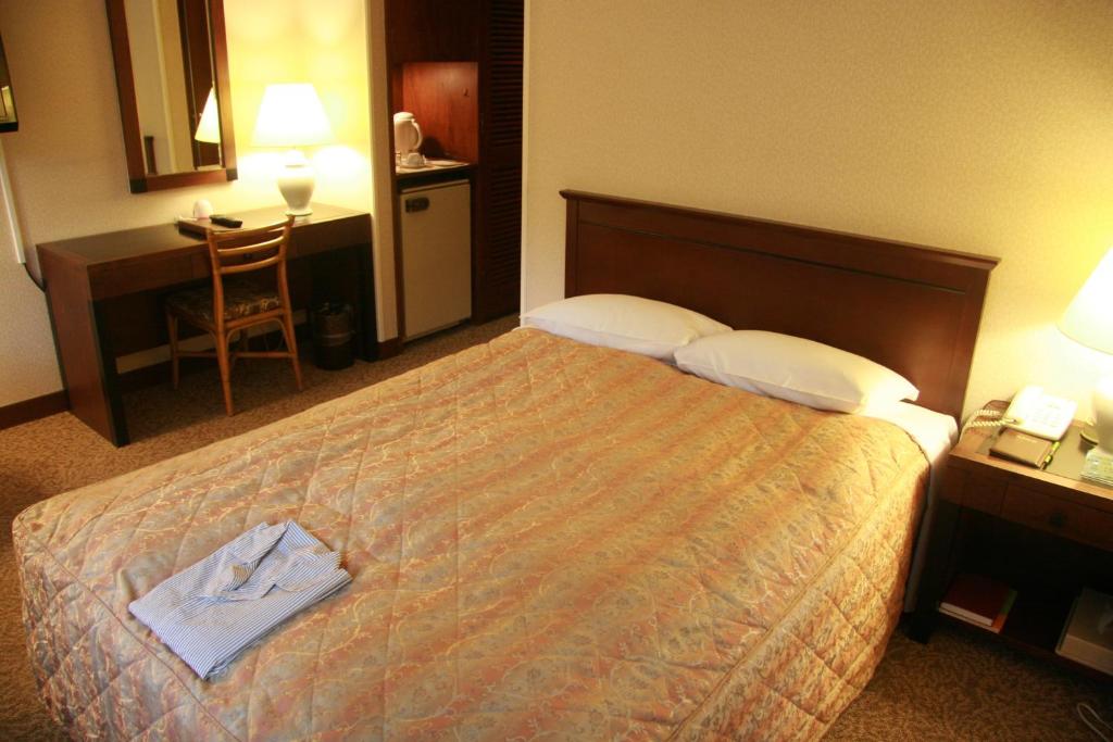 Postel nebo postele na pokoji v ubytování Kyu Karuizawa Hotel Otowa No Mori