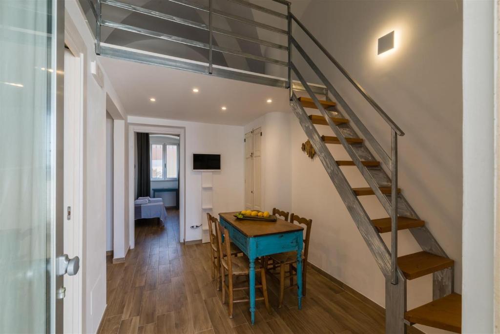 a staircase in a room with a table and a dining room at Casetta Mare in Villanova di Ostuni