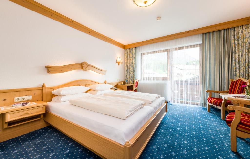 Postel nebo postele na pokoji v ubytování Hotel Moserhof