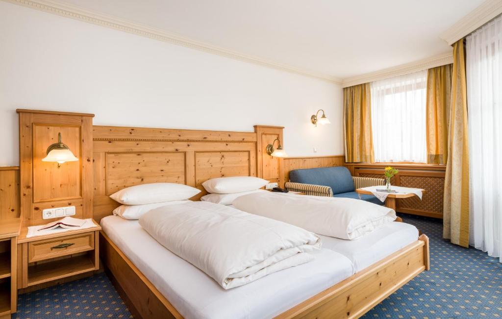 Postel nebo postele na pokoji v ubytování Hotel Moserhof