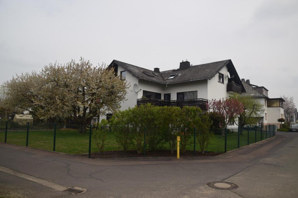 a white house with a fence in front of it at Fewo Landweg in Limburg an der Lahn