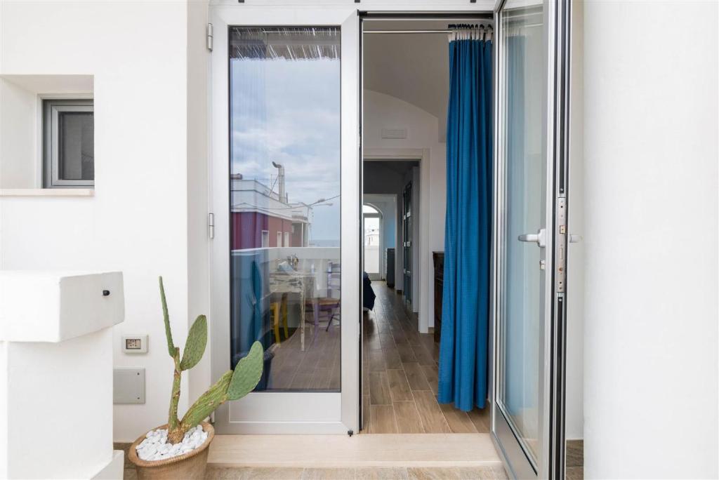 a glass door in a room with a hallway at Casetta Mare in Villanova di Ostuni