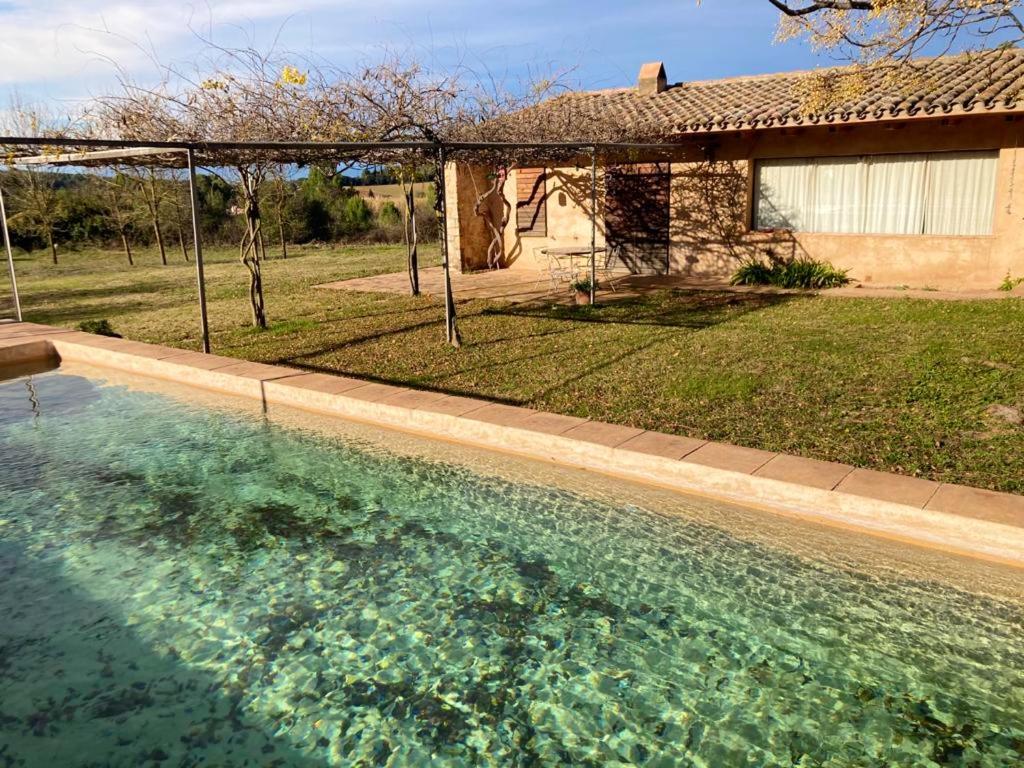 a large pool of water in front of a house at 4 bedrooms villa with private pool enclosed garden and wifi at Camallera in Camallera