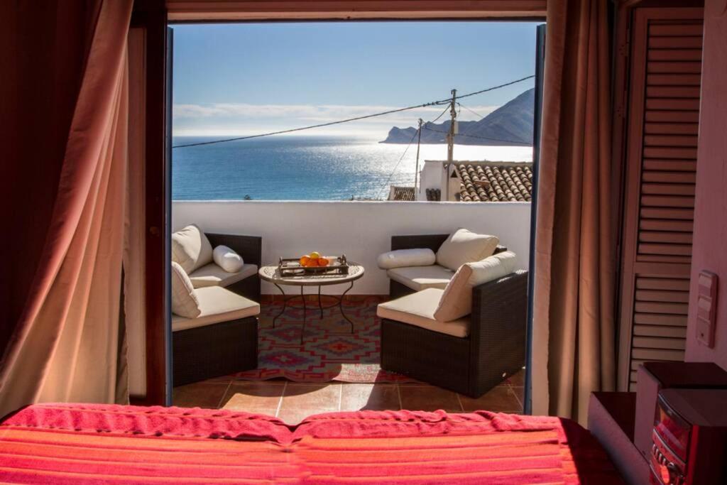 a room with a balcony with a view of the ocean at Casa con piscina Gades-Marisol in Altea